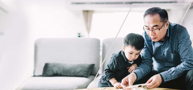 Father and son playing in the living room